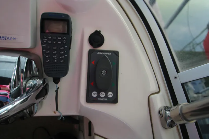 Slide: The Image of Control panel of a 2007 Meridian 391 Sedan boat with radio and thruster controls. - 46