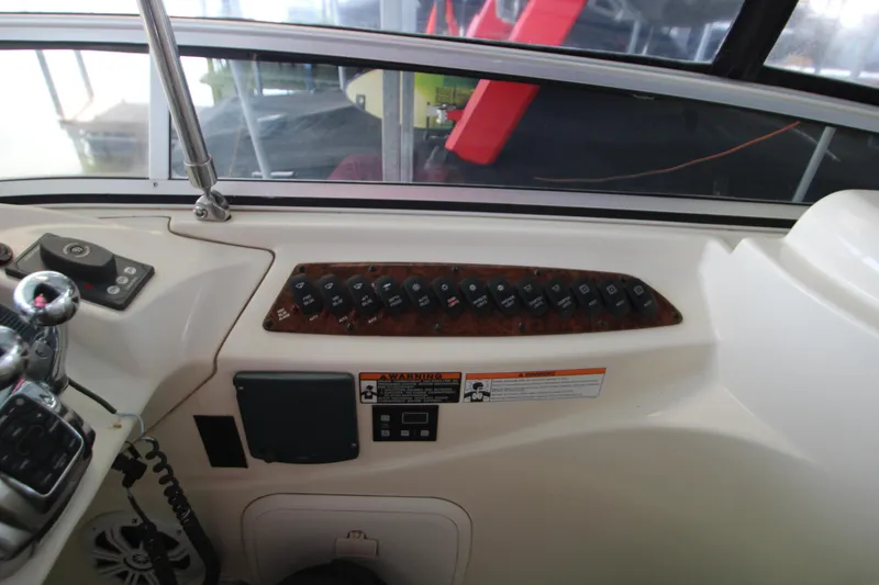 Slide: The Image of Control panel of a 2007 Meridian 391 Sedan boat, featuring switches and levers. - 47