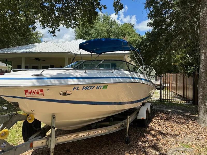 Slide: The Image of 2008 Regal 2250 Cuddy boat for sale on trailer, parked outdoors. - 2