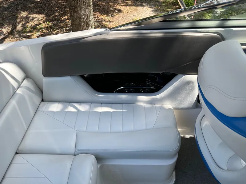 Slide: The Image of Interior of a 2008 Regal 2250 Cuddy boat with white seating and cup holders. - 21