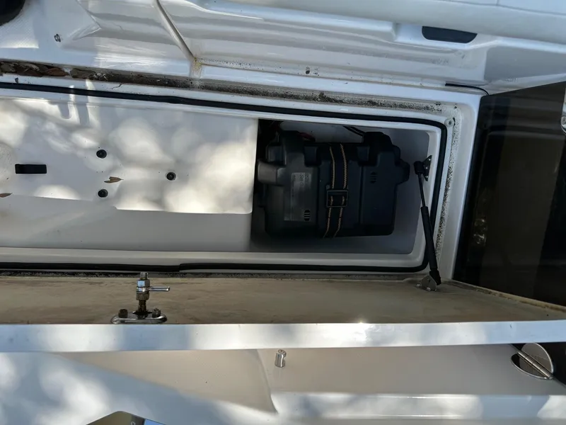 Slide: The Image of Open storage compartment in 2008 Regal 2250 Cuddy boat, showing battery box. - 22