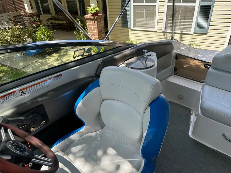 Slide: The Image of Interior of a 2008 Regal 2250 Cuddy boat with white and blue seating. - 23