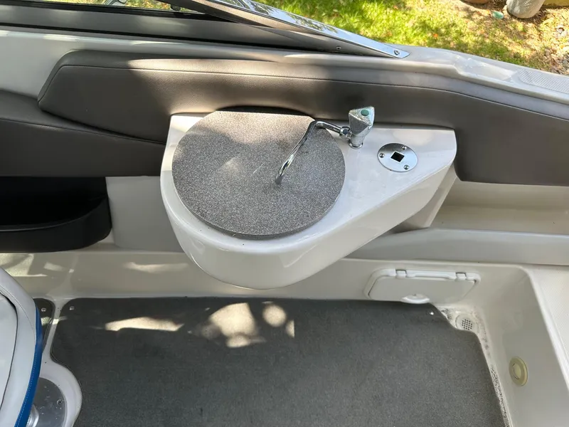 Slide: The Image of Interior of 2008 Regal 2250 Cuddy boat showing a compact sink and faucet. - 24