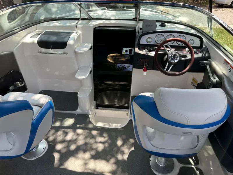 Slide: The Image of 2008 Regal 2250 Cuddy boat interior with steering wheel and seating. - 25