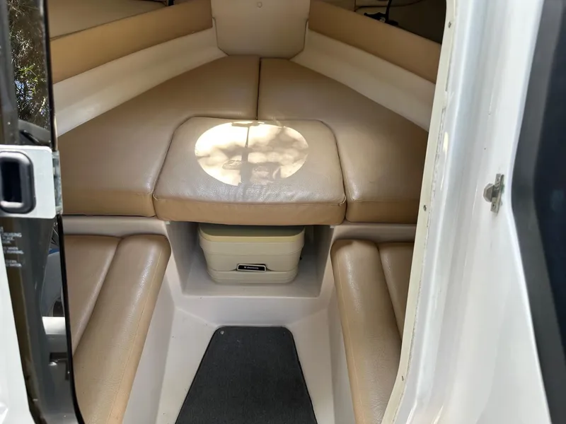 Slide: The Image of 2008 Regal 2250 Cuddy cabin interior with beige seating and compact design. - 33