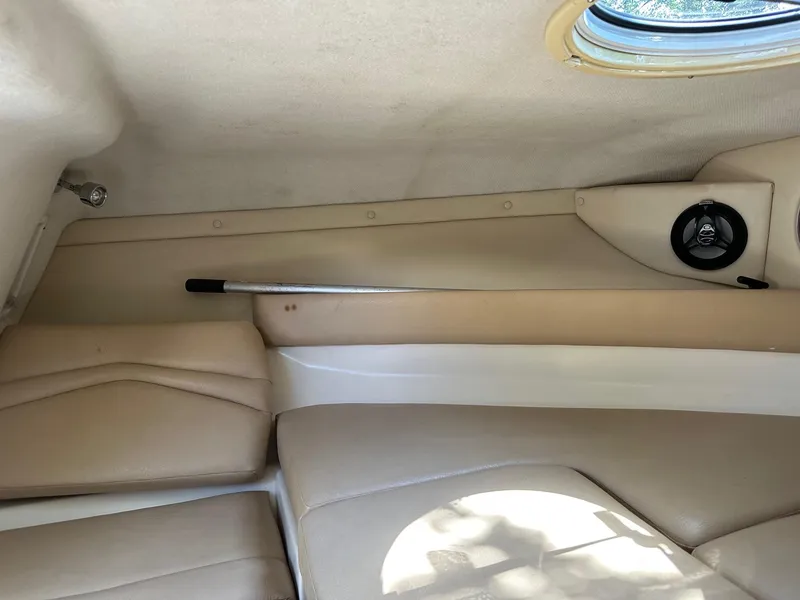 Slide: The Image of 2008 Regal 2250 Cuddy cabin interior with beige seating and speaker. - 36