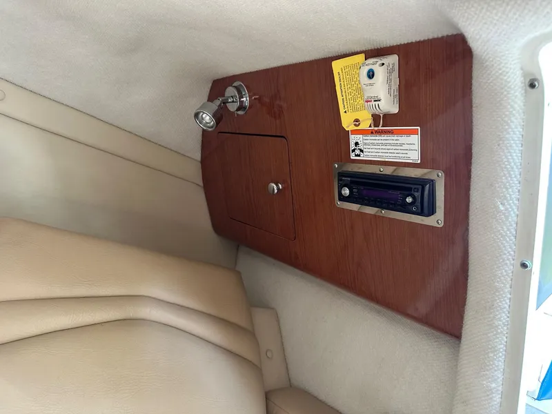 Slide: The Image of Interior of 2008 Regal 2250 Cuddy boat with wood panel and stereo system. - 38