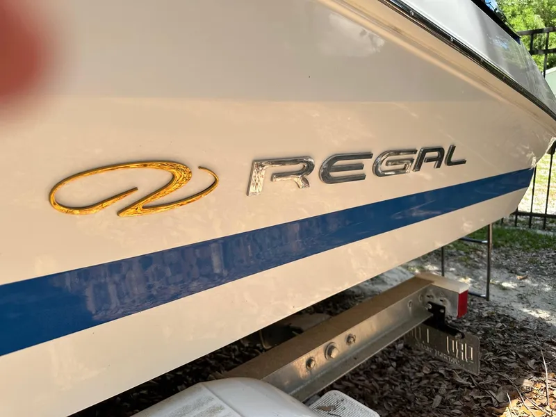 Slide: The Image of 2008 Regal 2250 Cuddy boat with logo and blue stripe on trailer. - 5