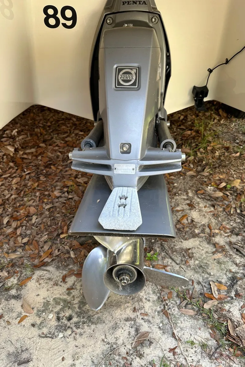 Slide: The Image of 2008 Regal 2250 Cuddy boat propeller and outdrive on sandy ground. - 7