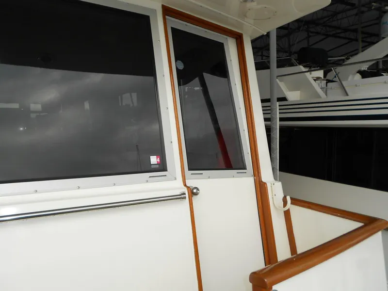 Slide: The Image of 1985 Chris-Craft 500 Constellation Motor Yacht exterior with wooden trim and windows. - 11