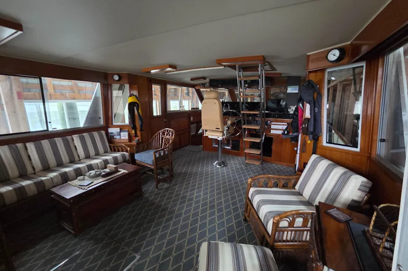 Slide: The Image of Interior of 1985 Chris-Craft 500 Constellation Motor Yacht with striped seating and wooden accents. - 12