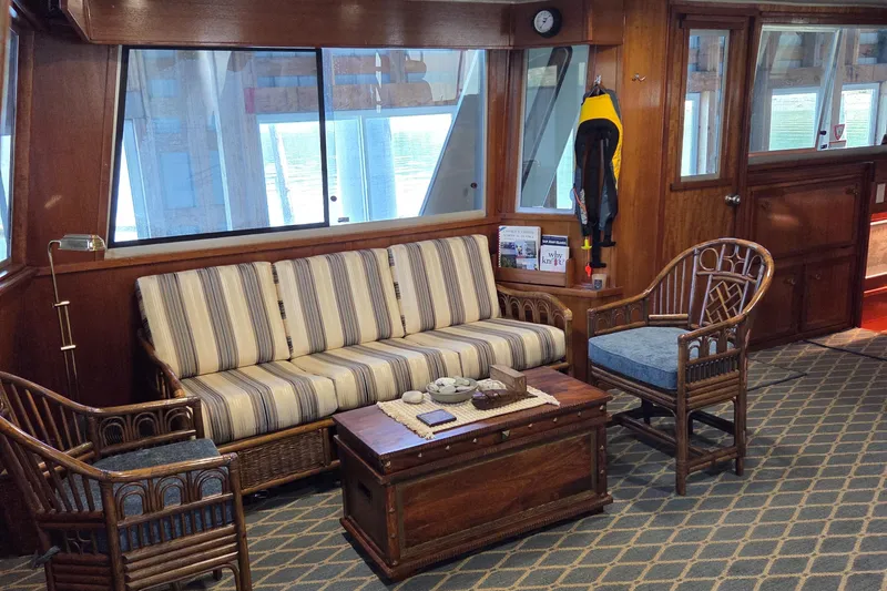 Slide: The Image of Interior of 1985 Chris-Craft 500 Constellation Motor Yacht with striped sofa and wooden furniture. - 13