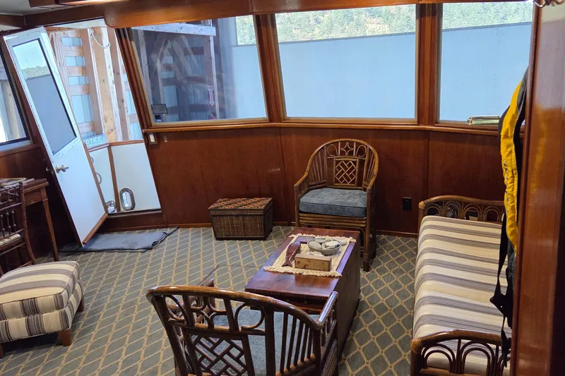 Slide: The Image of Interior of 1985 Chris-Craft 500 Constellation Motor Yacht with wooden furniture and striped upholstery. - 15