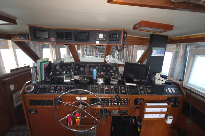 Slide: The Image of 1985 Chris-Craft 500 Constellation Motor Yacht helm with navigation instruments and steering wheel. - 16