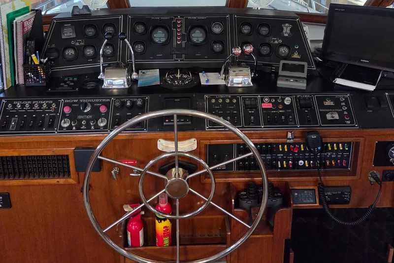 Slide: The Image of 1985 Chris-Craft 500 Constellation Motor Yacht helm with steering wheel and control panels. - 17