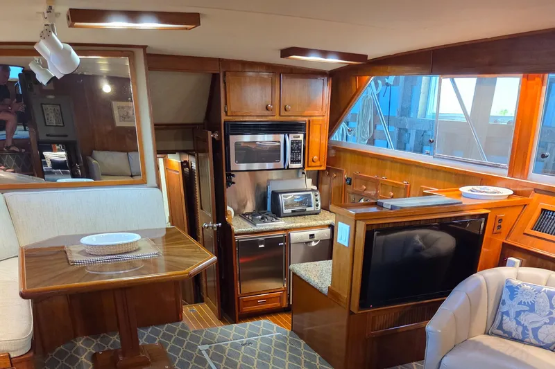 Slide: The Image of Luxurious interior of 1985 Chris-Craft 500 Constellation Motor Yacht with kitchen and dining area. - 21