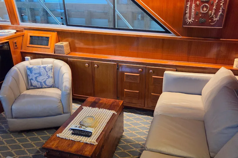Slide: The Image of Luxurious interior of 1985 Chris-Craft 500 Constellation Motor Yacht with elegant seating and wood finishes. - 23