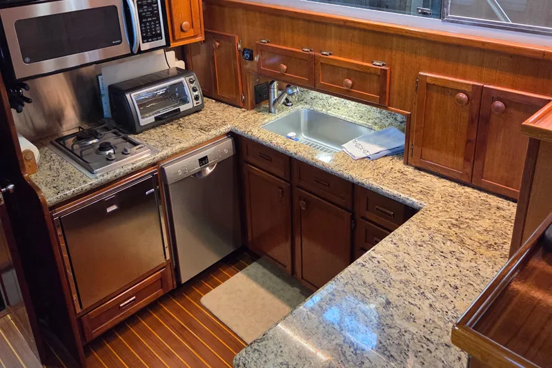 Slide: The Image of Luxurious kitchen in 1985 Chris-Craft 500 Constellation Motor Yacht with granite countertops and modern appliances. - 25