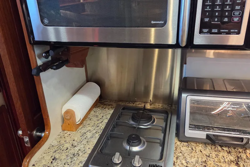 Slide: The Image of Kitchen area of 1985 Chris-Craft 500 Constellation Motor Yacht with stove and appliances. - 26