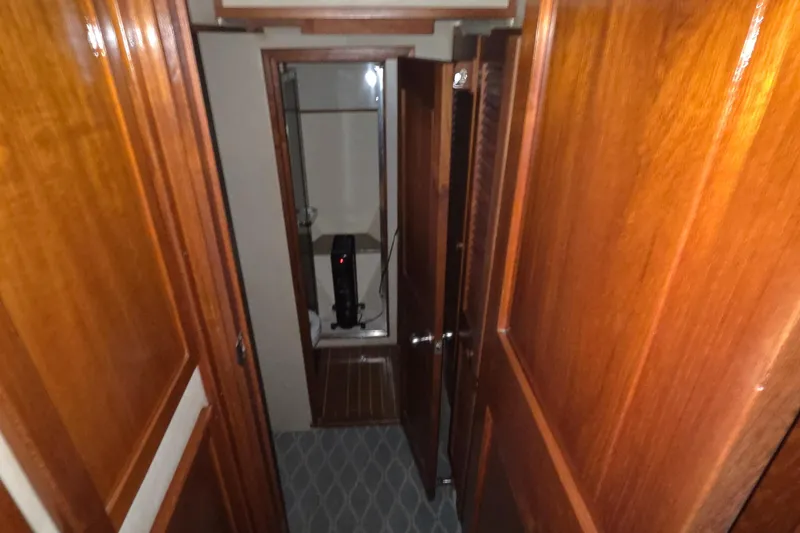 Slide: The Image of 1985 Chris-Craft 500 Constellation Motor Yacht interior hallway with wooden paneling. - 29