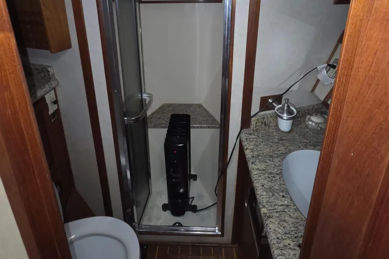 Slide: The Image of 1985 Chris-Craft 500 Constellation Motor Yacht bathroom with granite countertops and shower. - 30