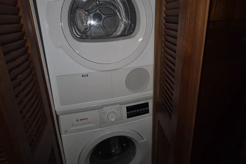 Slide: The Image of Stacked Bosch washer and dryer in wooden cabinet on 1985 Chris-Craft 500 Constellation Motor Yacht. - 32
