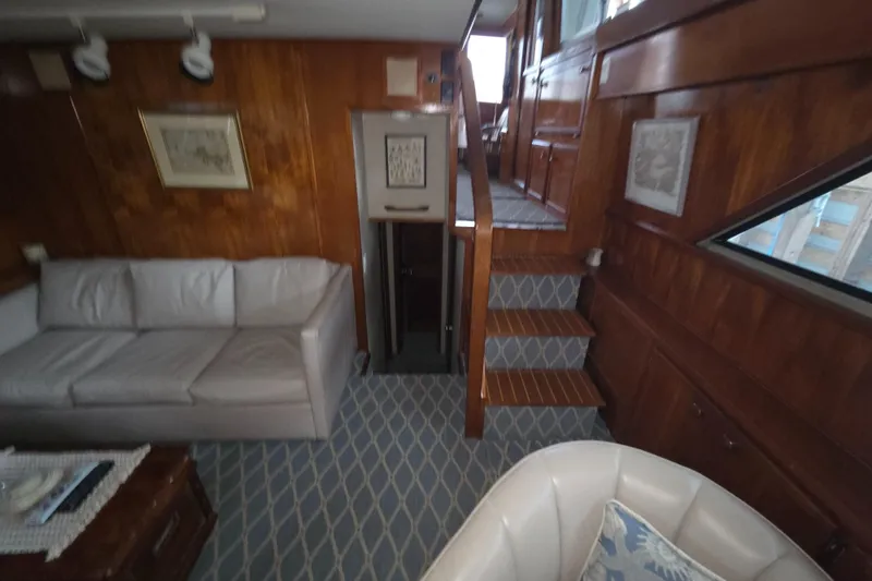 Slide: The Image of Interior of 1985 Chris-Craft 500 Constellation Motor Yacht with wood paneling and seating area. - 33