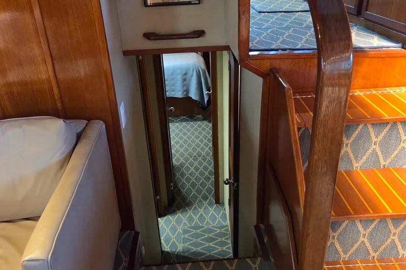 Slide: The Image of Interior of 1985 Chris-Craft 500 Constellation Motor Yacht with wooden stairs and carpeted hallway. - 34
