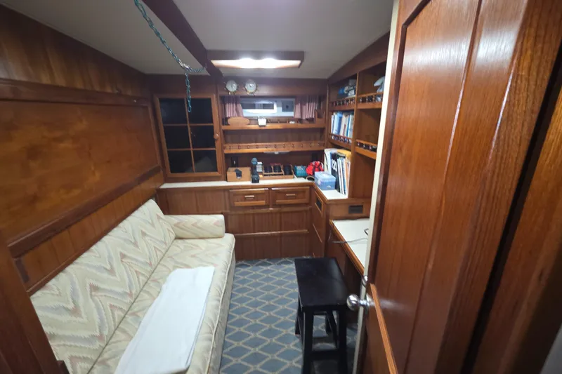 Slide: The Image of 1985 Chris-Craft 500 Constellation Motor Yacht interior with wood paneling and cozy seating area. - 35