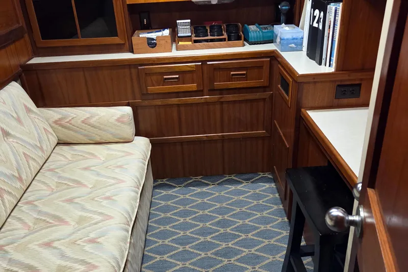 Slide: The Image of Interior of 1985 Chris-Craft 500 Constellation Motor Yacht with wood cabinetry and patterned sofa. - 36