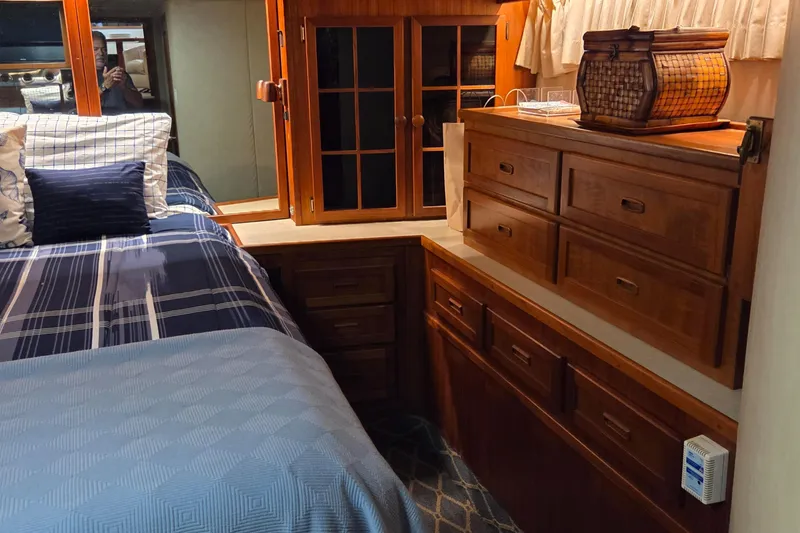 Slide: The Image of Luxurious 1985 Chris-Craft 500 Constellation Motor Yacht bedroom with wooden cabinetry and cozy bedding. - 38