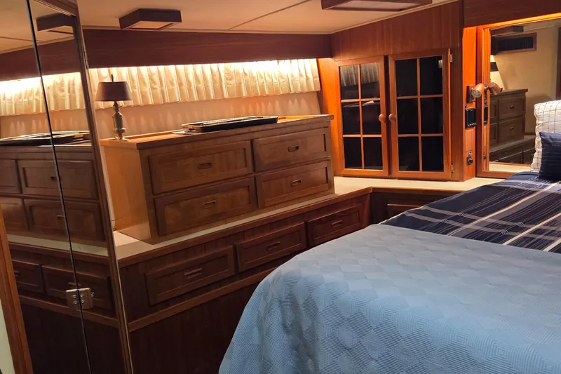 Slide: The Image of Luxurious 1985 Chris-Craft 500 Constellation Motor Yacht bedroom with wood cabinetry and cozy bedding. - 39