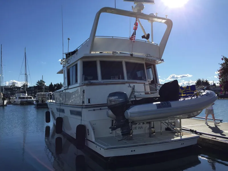 Slide: The Image of 1985 Chris-Craft 500 Constellation Motor Yacht docked in a sunny marina. - 4