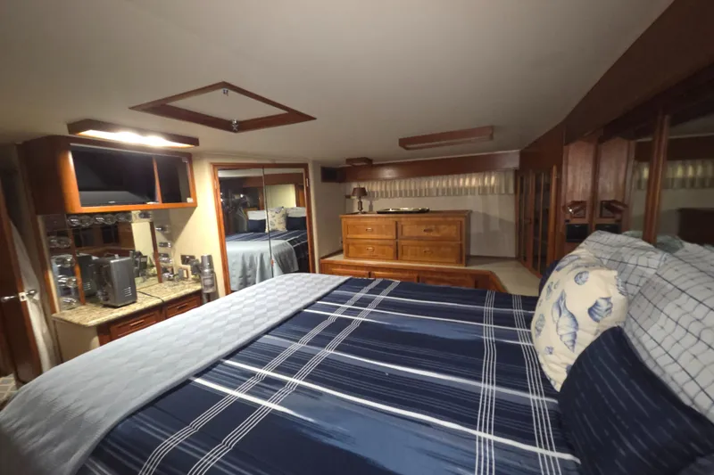 Slide: The Image of Luxurious bedroom interior of 1985 Chris-Craft 500 Constellation Motor Yacht with elegant wood furnishings. - 41