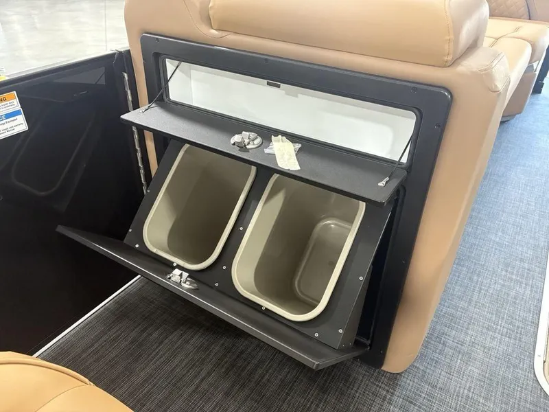 Slide: The Image of Built-in storage bins on Godfrey Sweetwater 2286 SB 2025 boat, featuring tan seating and modern design. - 10