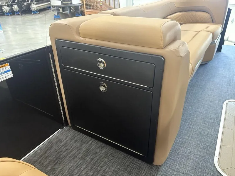 Slide: The Image of Interior of 2025 Godfrey Sweetwater 2286 SB boat, featuring tan seating and storage compartments. - 11