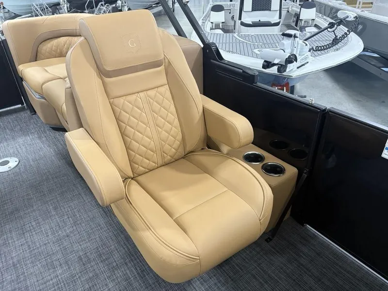 Slide: The Image of Luxurious tan seating on 2025 Godfrey Sweetwater 2286 SB pontoon boat, featuring cup holders. - 13