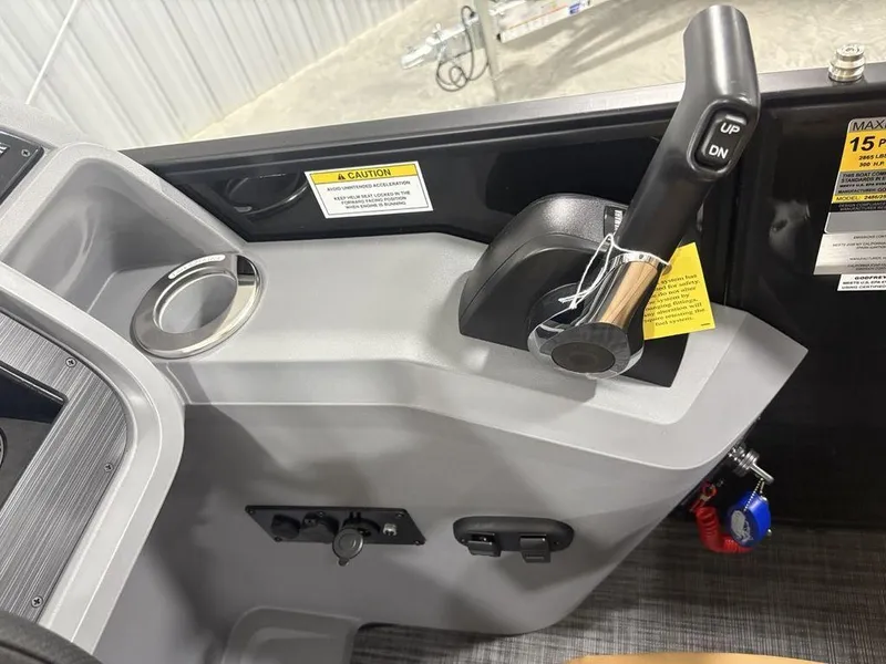 Slide: The Image of Control panel of 2025 Godfrey Sweetwater 2286 SB boat with throttle and cup holder. - 15