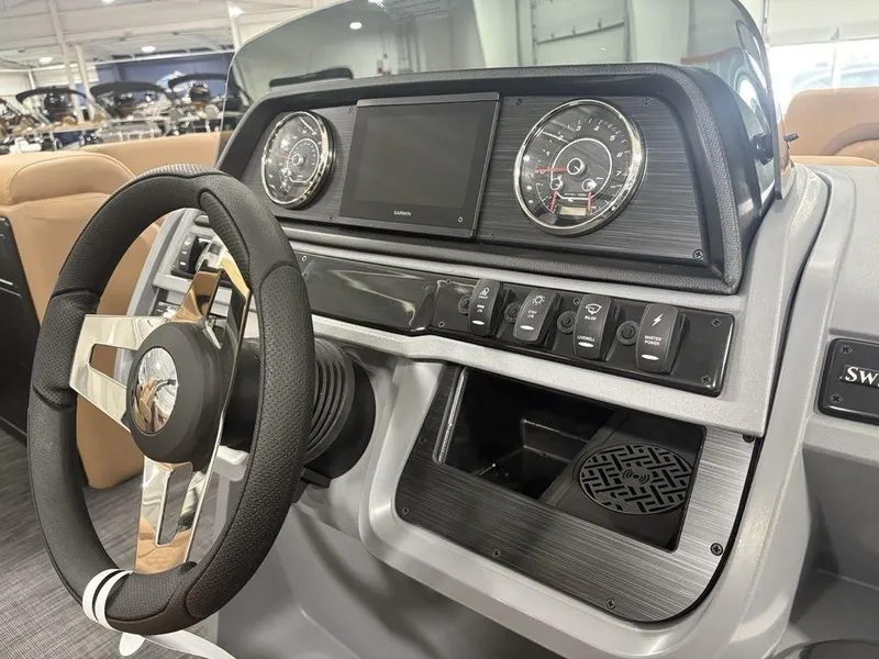 Slide: The Image of 2025 Godfrey Sweetwater 2286 SB boat dashboard with steering wheel and control panel. - 16