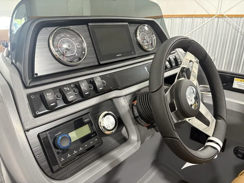 Slide: The Image of 2025 Godfrey Sweetwater 2286 SB boat dashboard with steering wheel and control panel. - 17