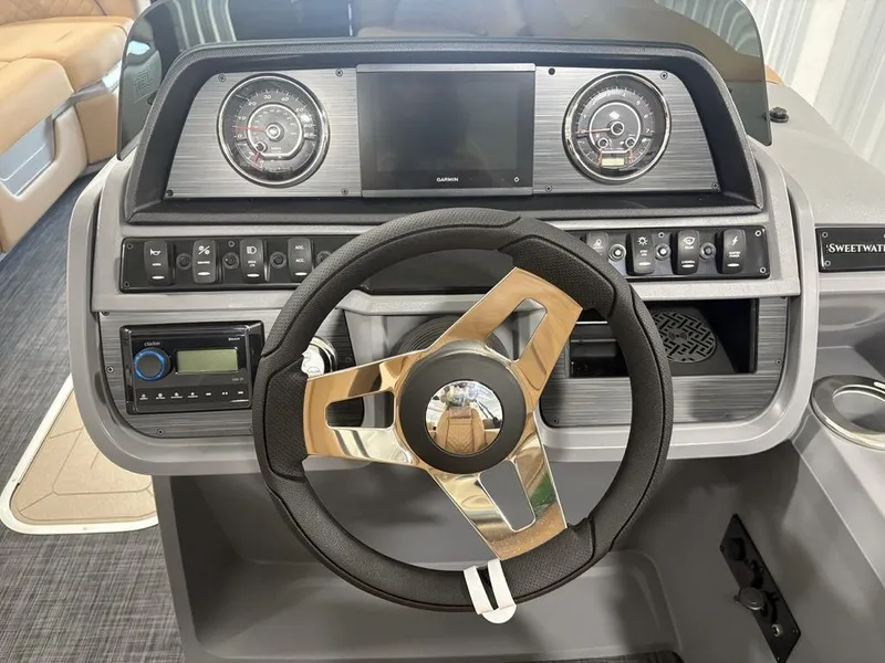 Slide: The Image of Steering console of 2025 Godfrey Sweetwater 2286 SB pontoon boat with modern controls. - 18