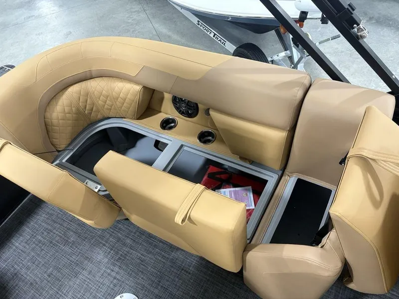 Slide: The Image of 2025 Godfrey Sweetwater 2286 SB boat interior with tan seating and storage compartments. - 25