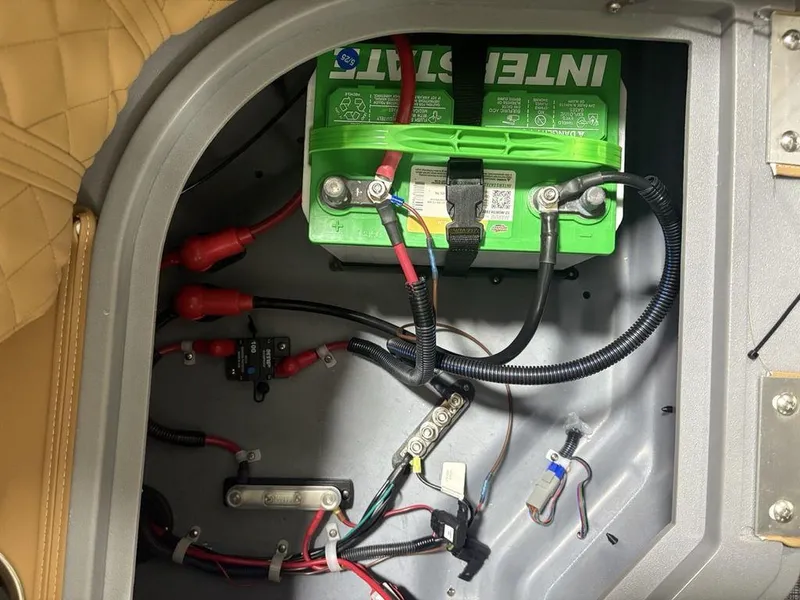 Slide: The Image of Battery compartment of 2025 Godfrey Sweetwater 2286 SB boat, featuring wiring and connections. - 26