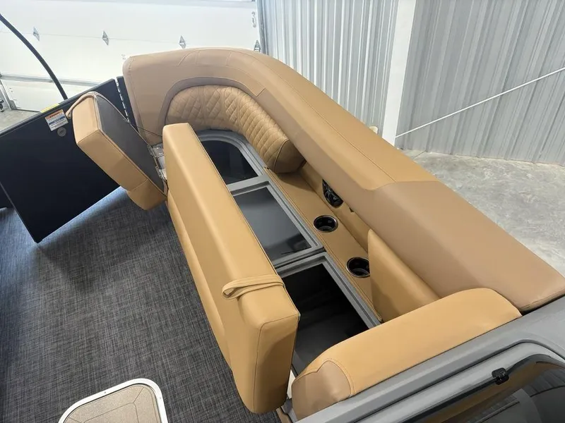 Slide: The Image of Interior seating of 2025 Godfrey Sweetwater 2286 SB boat with tan upholstery and storage compartments. - 3