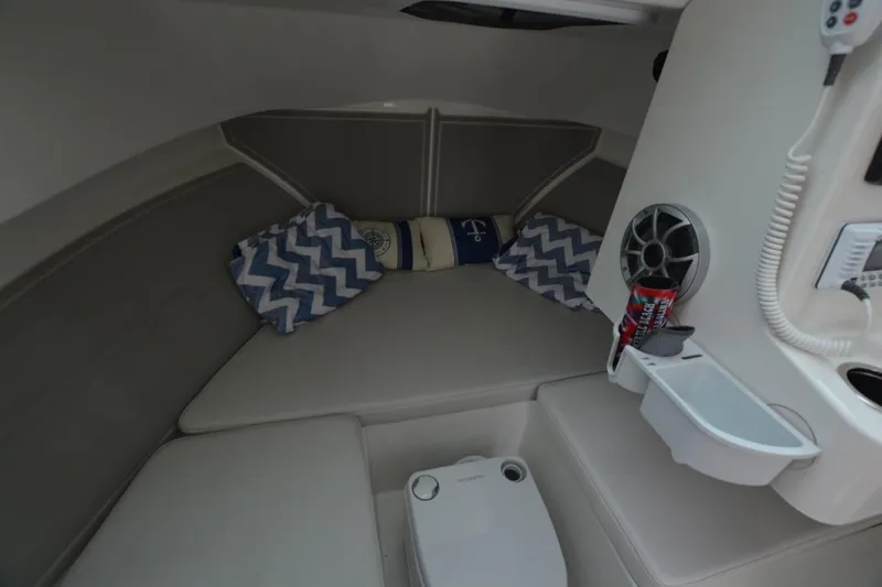 Slide: The Image of Cozy cabin interior of 2025 Parker 2420 boat with cushions and speaker. - 10