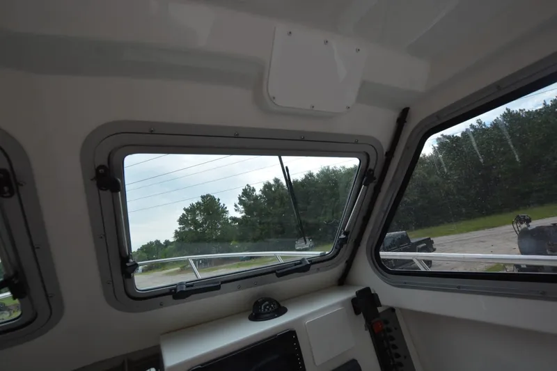 Slide: The Image of Interior view of Parker 2420 boat, showcasing windows and dashboard, 2025 model. - 12