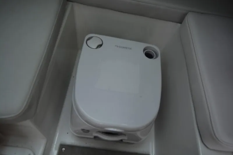 Slide: The Image of Portable toilet in Parker 2420 boat, 2025 model, with compact design and white finish. - 14