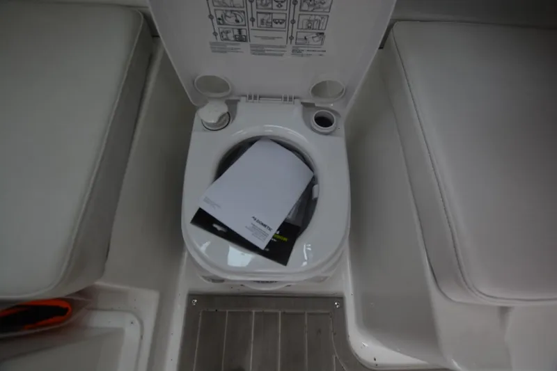Slide: The Image of Boat toilet with open lid, Parker 2420 model, 2025, featuring instruction manuals inside. - 15