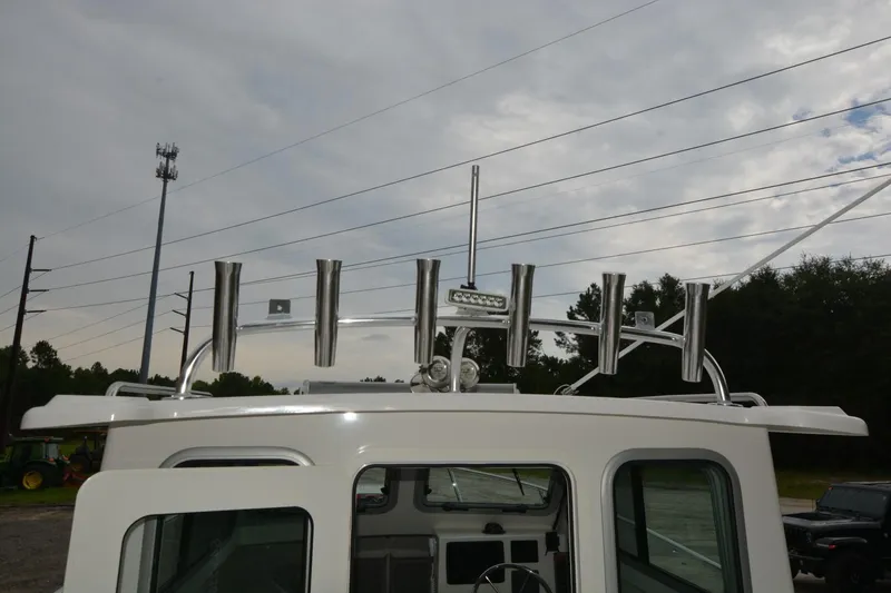 Slide: The Image of Rooftop view of 2025 Parker 2420 boat with rod holders and antenna. - 17
