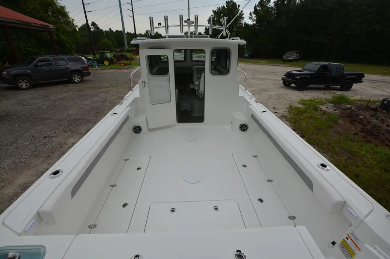 Slide: The Image of 2025 Parker 2420 boat with spacious deck, parked outdoors. - 18